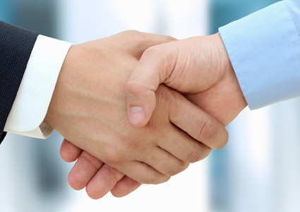 Close-up image of a firm handshake  between two colleagues